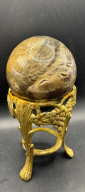 Baby squirrel on vintage brass base